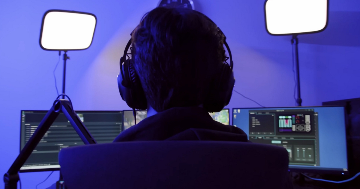 Guy sitting in front of a computer playing video games