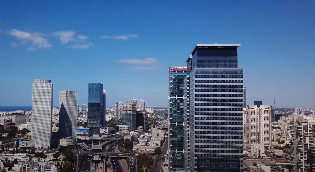 A sprawling cityscape, bathed in brilliant sunlight