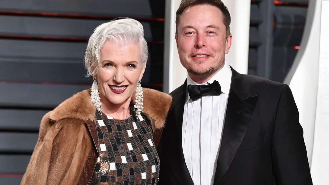 Maye Musk and Elon Musk posing together at an event