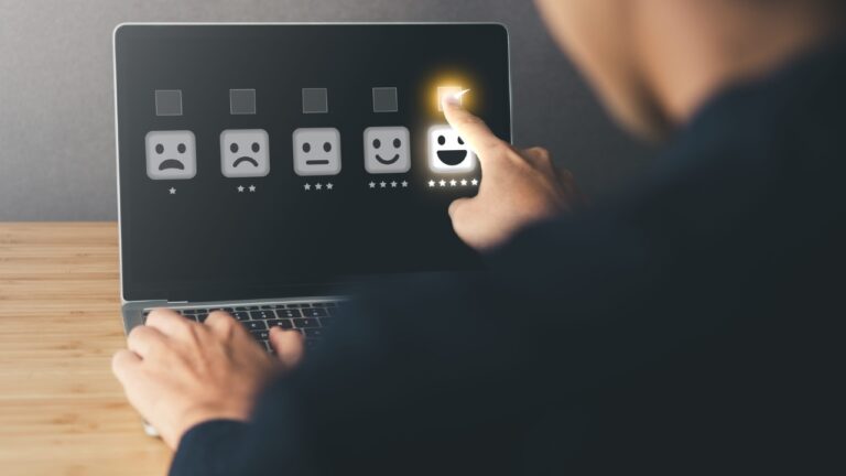 A customer selects a five-star satisfaction rating on a laptop screen.